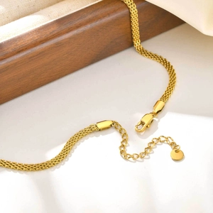 Detail of golden mesh necklace with lobster clasp and adjustable extension chain