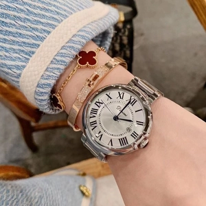 Elegant silver stainless steel watch with Roman numeral dial on a female wrist