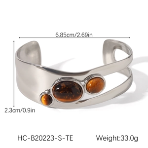 Detail view of steel tiger eye open bangle with size measurements 6.85cm by 2.3cm