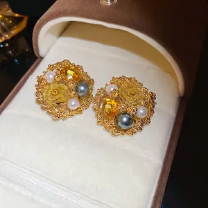 Elegant gold flower earrings with yellow crystal and pearls in a velvet jewelry box