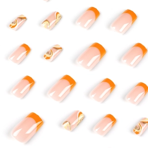 Orange French press-on nails set with gold glitter waves and glossy square-oval shape