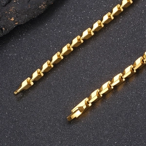 Macro detail of golden stainless steel keel chain set with unique geometric link structure