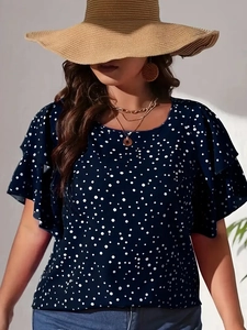 Detail of navy blue blouse with white polka dots and double-layered ruffle sleeves