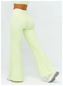 Detail view of high-waisted flared yoga pants in light green with seamless booty lifting design