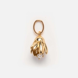 Detailed view of flower bud pendant in gold finish with small inlaid gemstone