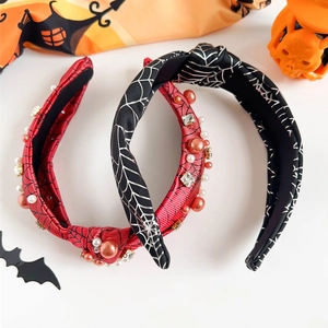 Detail of Halloween knotted headbands with spider web patterns, pearls and rhinestones