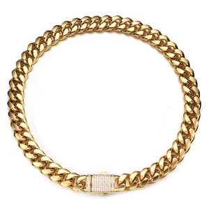 Close-up of golden Cuban chain link necklace with a sparkling white rhinestone buckle