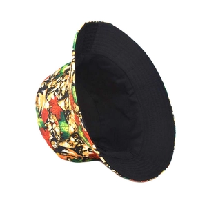 Detail of reversible bucket hat featuring realistic kitten prints and autumn maple leaves