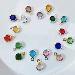 Macro shot of colorful round glass crystal charms with gold and silver plated metal frames