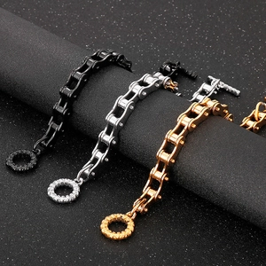 Detail of chunky stainless steel bike chain bracelets in black, silver and gold finish