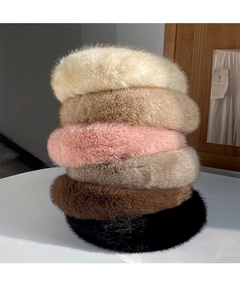 Detailed stack of six plush mink fur headbands in various neutral colors for winter