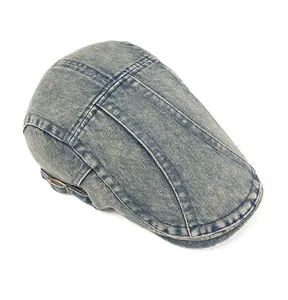 Top down view of washed blue denim newsboy cap showing stitching and fabric texture
