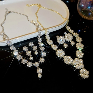 Detailed view of luxury pearl and diamond flower jewelry sets in gold and silver finishes