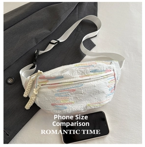 Detail of white pleated canvas chest bag with colorful wave embroidery and woven rope zipper