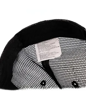 Detailed view of the care label and breathable mesh fabric inside the baseball cap