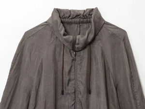 Detailed view of dark brown bomber jacket neckline with high-quality drawstring and stitching