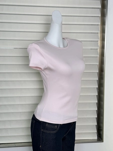 Side view of pink slim fit short sleeve T-shirt with round neck and hourglass waist cut