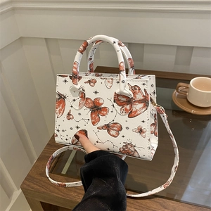 Borsa bianca in pelle con stampa farfalle, doppi manici e tracolla sottile inclusa
