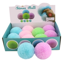 Set of 12 colorful sensory puffer stress balls in a display box for kids
