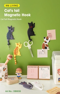 Cat tail magnetic fridge hooks in multiple colors holding keys and scissors on wall