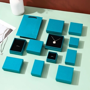 Detailed set of cyan jewelry boxes and matching tote bag with black velvet lining