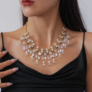 Detail shot of vintage tiered tassel necklace with faux pearls and crystals on a model