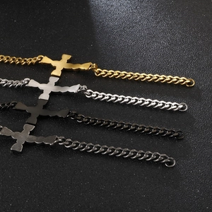 Detail view of Cuban link bracelets with cross pendants in gold, silver, black, and gunmetal