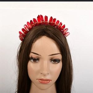 Close-up of handmade gold wire-wrapped raw red crystal headband on a model head