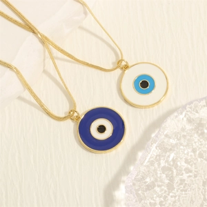 Macro detail of 18K gold-plated snake chains and blue enamel evil eye pendants