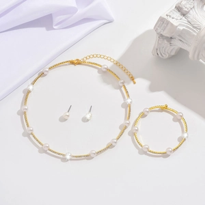 Elegant gold jewelry set with pearls and zircons including necklace bracelet and earrings