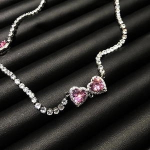 Macro detail of luxury pink heart-shaped pendant necklace with cubic zirconia pavé
