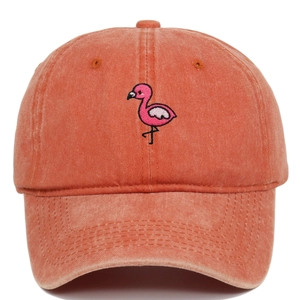 Close-up of pink flamingo embroidery on washed cotton vintage brick red baseball cap