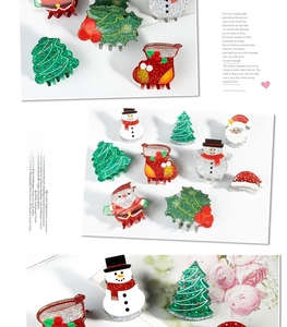 Detail view of glittery Christmas tree and Santa hair clips in festive red and green