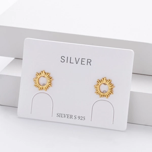 Detail of S925 sterling silver sunburst stud earrings with polished gold finish