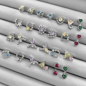 Macro shot of assorted colorful zircon stud earrings in heart, star, and moon shapes