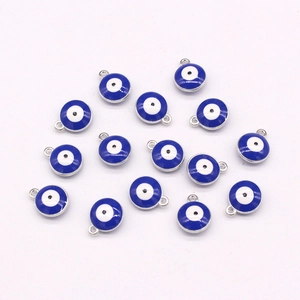 Detailed view of blue enamel evil eye pendants with silver metal frames for DIY jewelry