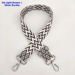 Close-up of light coffee and cream wave pattern woven guitar strap with silver metal buckle
