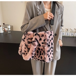 Detail of pink leopard plush tote bag with adjustable black strap and gold hardware