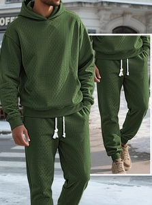 Detailed view of dark green tracksuit featuring jacquard diamond texture and ribbed cuffs