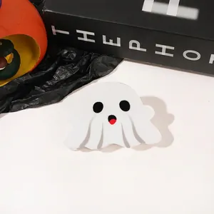 Close-up of a cute white acrylic ghost hair claw clip with Halloween pumpkin decor