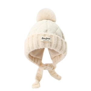 Winter fleece-lined earmuff hat for kids with fluffy pompom and patchwork knit design
