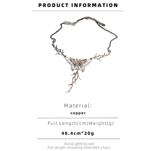 Detail of copper butterfly and thorn necklace with antique silver finish texture