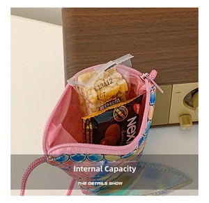 Detail view of the inner storage capacity of the pink sequin fish tail shoulder bag
