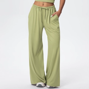 Detail of sage green drawstring elastic waistband and soft fabric on wide-leg trousers