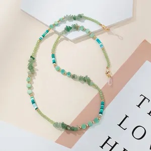 Detail of beaded eyewear chain with green stones, golden accents and silicone loops
