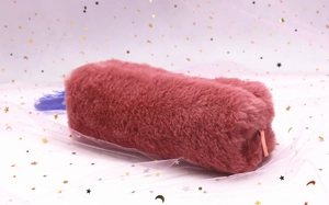 Close-up of pink faux fur pencil case with elegant rose gold metal zipper detail