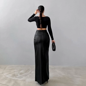 Detail view of high waisted black faux leather maxi skirt with back slit design