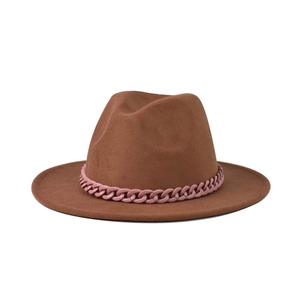 Detailed close-up of brown classic fedora hat featuring a stylish pink link chain decoration