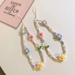 Detailed view of colorful macaron beaded phone charms with tulip flower beads and strap