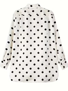 Detailed back view of white long-sleeved shirt with black polka dots and cuffed sleeves